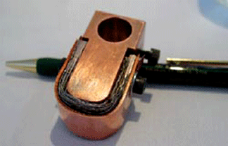 Fig 5 Honeycomb spot-welder head with copper-braided wire cable below the copper strips. The design allows the head to conform to the honeycomb when tacking it into place