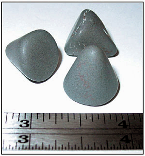 Fig 1 Aluminum-oxide pyramid stones used in tumble deburing.