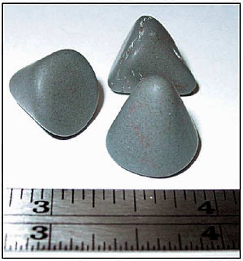 Fig 1 Aluminum-oxide pyramid stones used in tumble deburring.