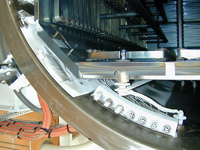 Fig. 4 Mg-condensation board inserted into furnace at left can be removed to scrape off Mg and then re-inserted into furnace. Notice the Mg coating on the board does not stick, and is already wanting to peel off the surface of the insert. (Photo courtesy of PV/T.)
