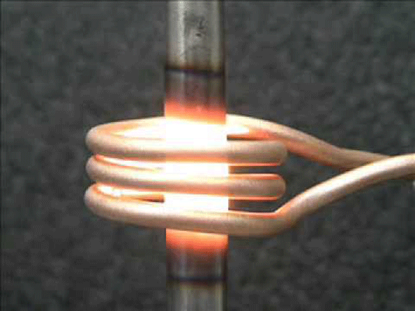 Fig. 1 -- Induction coil used to heat a metal post. Photo courtesy of GH Induction Atmospheres.