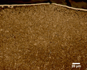 Fig. 2. Carburized Component Exhibiting IGO to a Depth of Approximately 0.020 mm (0.007”) (Photograph Courtesy of George Vander Voort Consulting)