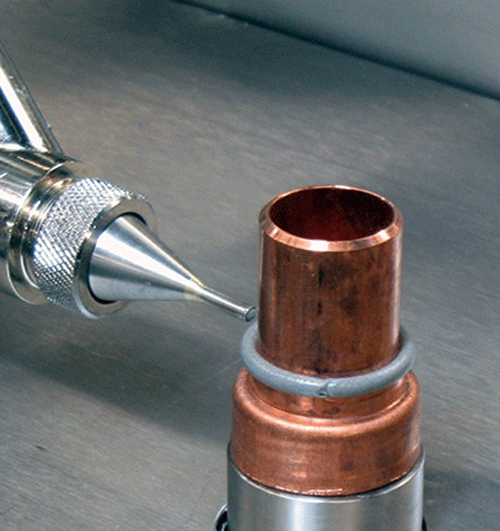 Figure 8. Brazing paste being dispensed from a PDD system. Such BFM paste application is highly repeatable and accurate.