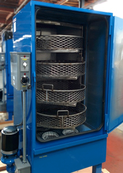 Fig. 1 -- Aqueous cleaning cabinet, in which parts can be loaded in separate trays, one above the other, for thorough cleaning. Photo courtesy of Equipment Manufacturing Corporation (EMC), Santa Fe Springs, CA.