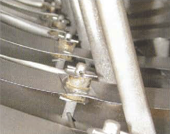 Fig 6. (Bottom) Ceramic insulators that support the heating elements on the support pins can short circuit due to contamination build-up, vaporizing the material at the location of the short circuit.