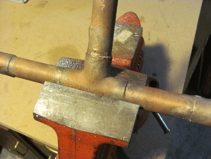 Fig. 1 Tubular assembly being held in a metal vise.