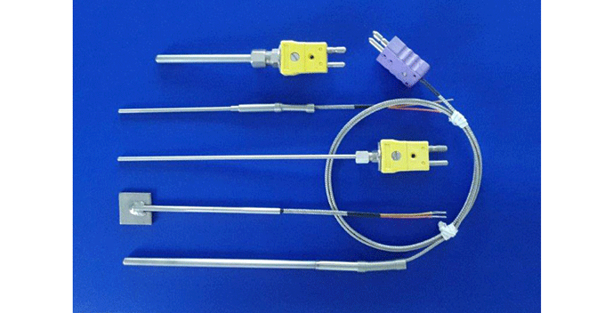 Fig. 1 Typical examples of sheathed thermocouples (TC’s). Note the TC that is welded to a metal square as an aid in attaching that TC to some component. (Photo courtesy of Precision Measurements, Inc., Atlanta, GA).