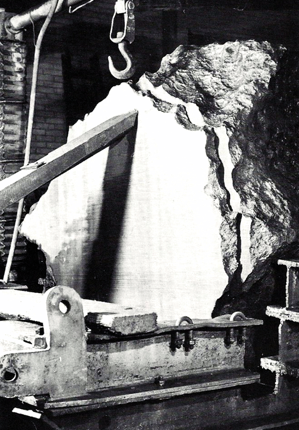 Figure 5: The 20 ton Agpalilik mass of the Cape York meteorite (one of 4 massive pieces found) was sectioned in October 1970 using a wire saw fed through a carborundum water slurry. Two cuts were made, 5 cm apart, each requiring about 195 hours to complete. The area was ~1.4 sq. m and weighted 560 kg. Six additional pieces were cut weighing from 428 to 893 kg over a 760 h period. The lower half of the above slab was ground, polished and macroetched and can be seen at the Mineralogical Museum of Copenhagen. Photo courtesy of Dr. Vagn Buchwald [1].