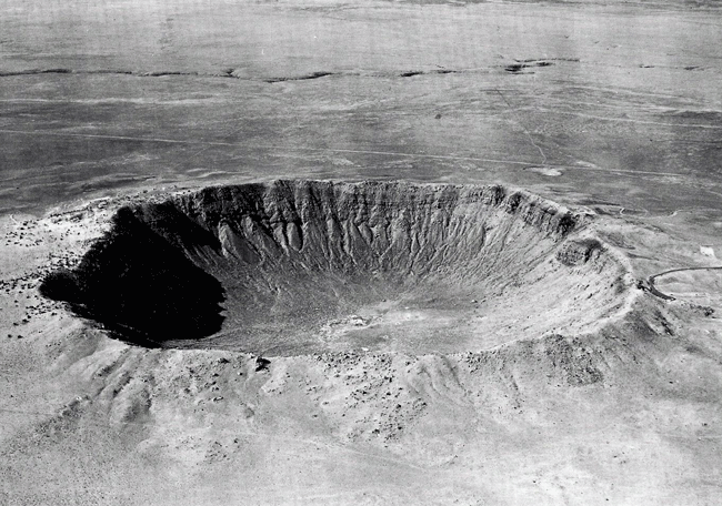 Figure 1: View of the Canyon Diablo meteor crater facing west in Coconino County, Arizona. The crater is approximately circular in shape. About 30 tons of specimens are in collections all over the world making it the most widely studied meteorite. Local natives built camps on the edge of the crater rim that have been dated to the 12th century. Photo courtesy of Dr. Vagn Buchwald [1].