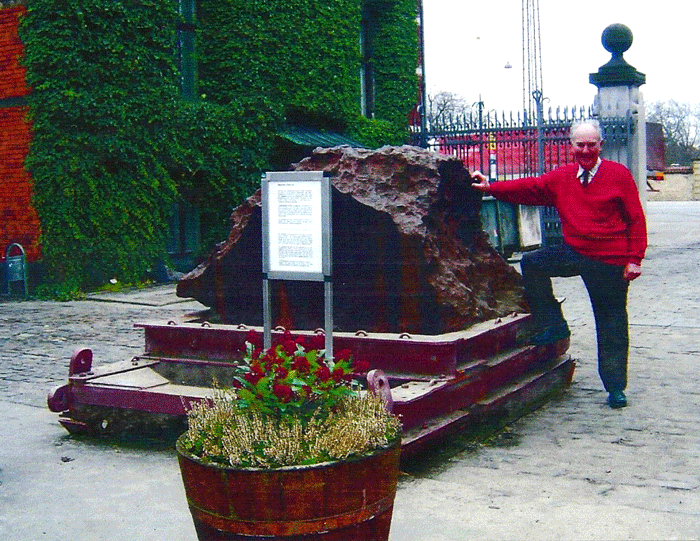 Figure 7: Vagn Buchwald with a section from the 20-ton Agpalilik fragment of the Cape York meteorite, found on 31 July 1963 in Greenland, at the Geological Museum in Copenhagen in 2005 (Courtesy of Vagn Buchwald).