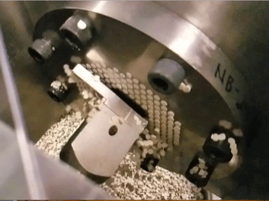 Fig. 1 Pelletizing die with a rapidly rotating cut-off knife to cut off plastic being continuously extruded through holes in the die. (Photo courtesy of The Bonnot Company, Akron, Ohio).