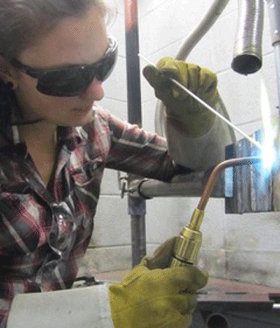 Fig. 1 A torch-brazer using a braze-welding technique to join two pieces of metal together. (Photo courtesy of Pinterest, San Francisco, CA)