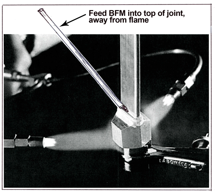 Fig. 9 Torch heat is held down on fitting, away from the top of the joint. The BFM is fed from the top of the joint, and the torch heat draws it down into the fitting. (Photo courtesy of JWHarris)