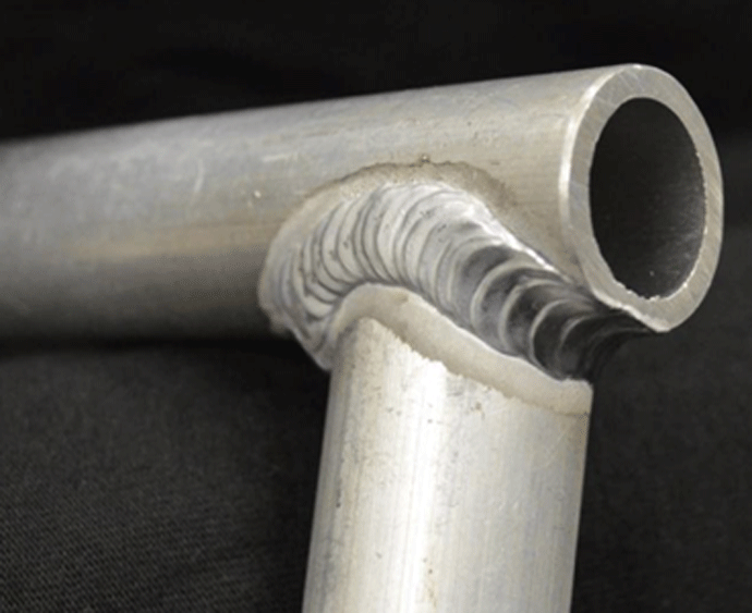 Fig. 6 Typical welded T-joints show one (or more) circular welds around the outside of the joint to create a strong, sound bond between the tubes. This weldment is between two aluminum tubes. Photo courtesy of Yashawa Motoman.